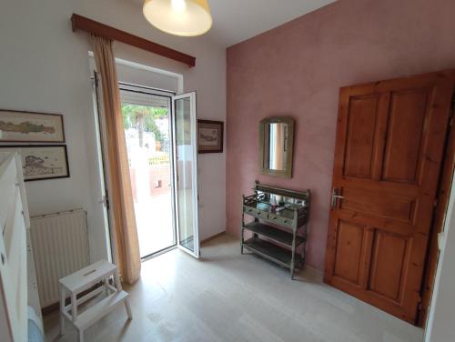 an empty room with a door and a room with a table at Dryades Villa in Arménoi