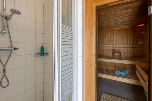 a shower with a glass door in a bathroom at Antibes 286 - Kustpark Village Scaldia in Hoofdplaat