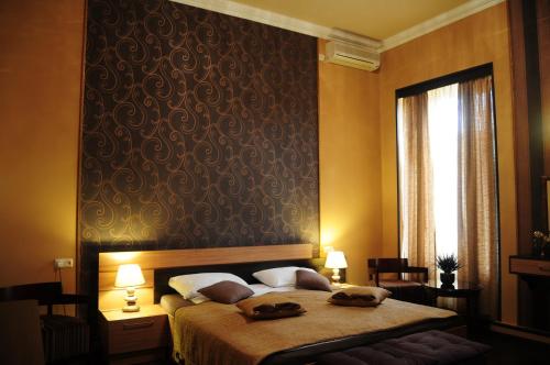 a bedroom with a bed with two towels on it at Azoyan Guest House in Yerevan
