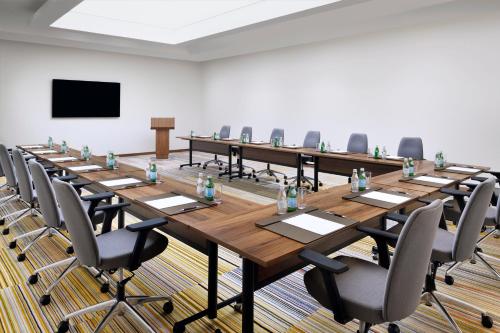 a large conference room with a long table and chairs at Movenpick Jumeirah Village Triangle in Dubai