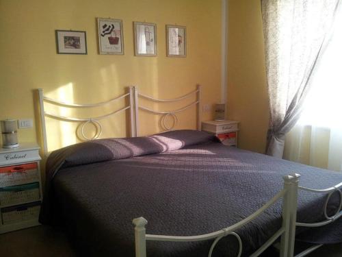 a bedroom with a bed with purple sheets and a window at Nonna Anita Palace Narni in Narni
