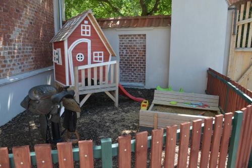 a childs play area with a house and a play yard at Statek Krkavčí Hora in Nižbor