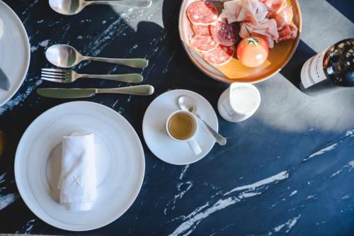 a table with a bowl of food and a cup of coffee at ORA Hotel Priorat, a Member of Design Hotels in Torroja