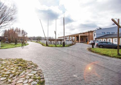 a cobblestone street in front of a building at Salio Equisport Resort in Stryków