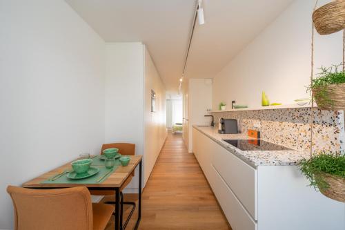 a kitchen with a table and a counter top at Georges & Madeleine Apartments in Aalst