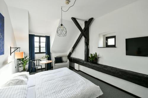 Una cama o camas en una habitación de Hotel Pivoňka