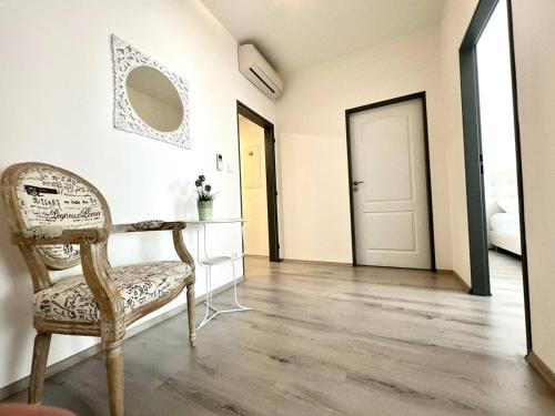 a room with a chair and a mirror and a door at Balu Apartments in Prague