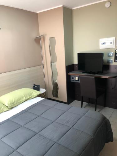 a bedroom with a bed and a desk with a computer at Villa Camilla Milano in Milan