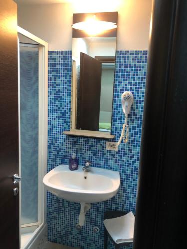 a bathroom with a sink and a mirror at Villa Camilla Milano in Milan