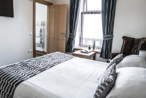a bedroom with a large bed and a window at Seaview Hotel in Peterhead