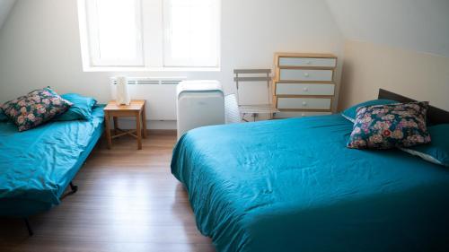 a bedroom with two beds and a desk and a window at SECRET MAMA 150 meters from public parking Montagne verte in Colmar