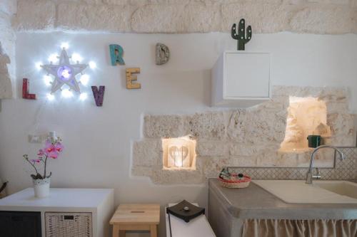 a kitchen with a sink and a counter top at Casa Anmori in Ostuni