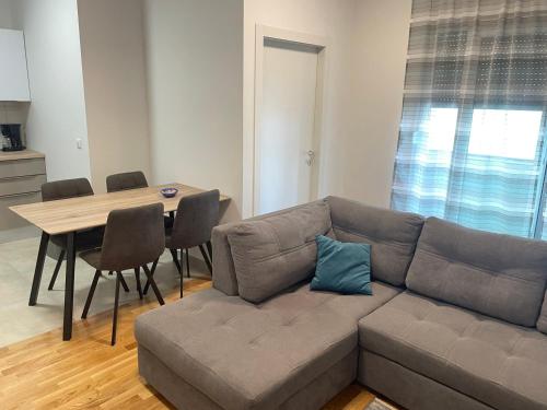 a living room with a couch and a table at Apartment Diana Zara parking free in Zadar