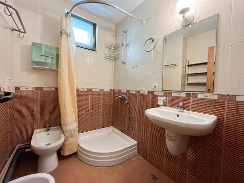 a bathroom with a sink and a toilet and a sink at Комплекс «ТОП» in Sveti Vlas