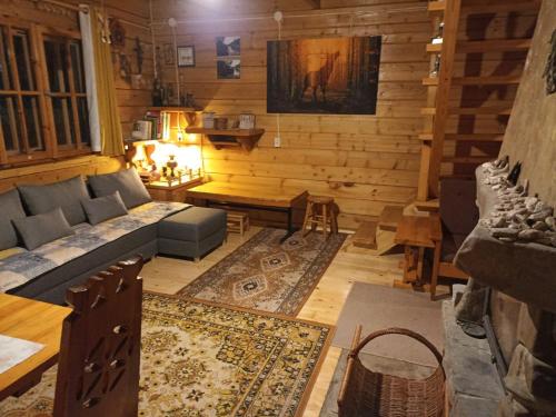 a living room with a couch and a table at DOMEK LETNISKOWY MYSCÓWKA in Krempna