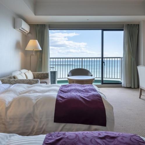 a hotel room with a bed and a large window at Onahama Ocean Hotel & Golf Club in Iwaki