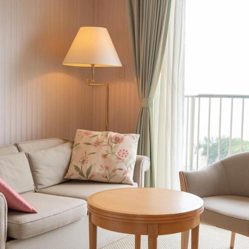 a living room with a couch and a table at Onahama Ocean Hotel & Golf Club in Iwaki