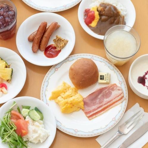 a table full of plates of food with different foods at Onahama Ocean Hotel & Golf Club in Iwaki