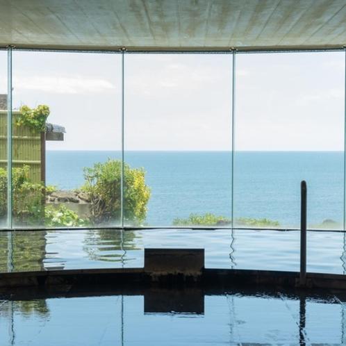 a room with a view of the ocean through glass at Onahama Ocean Hotel & Golf Club in Iwaki