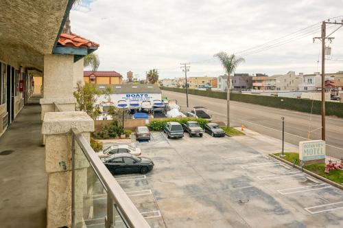 a view of a parking lot with cars parked on the street at OceanView Motel in Huntington Beach