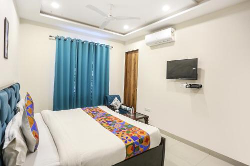 Una televisión o centro de entretenimiento en FabHotel Shiv Rachna - Mansarovar