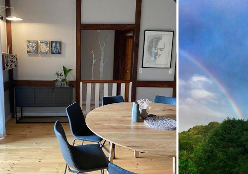 a dining room with a table and a rainbow at Forestchild Self Catering, The Crags in The Crags