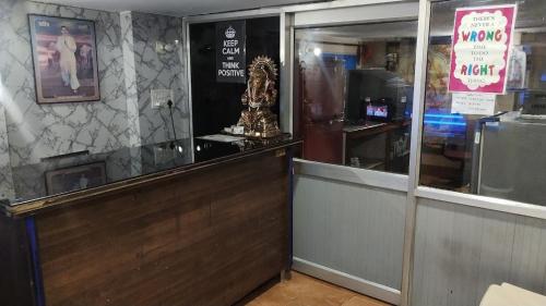 a restaurant with a counter and a cash register at Hotel Darpan By WB Inn in Jammu