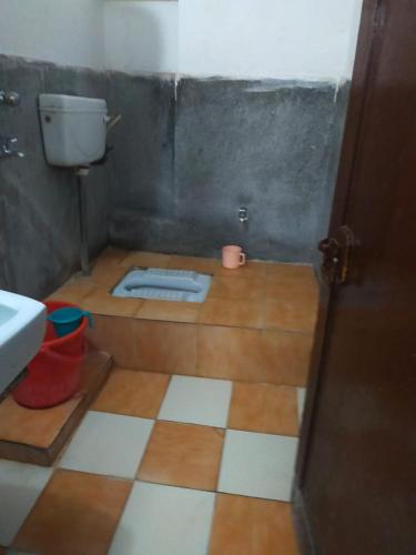 a bathroom with a toilet and a sink at Hotel Darpan By WB Inn in Jammu