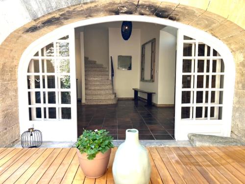 a white vase sitting on a wooden deck at La Villa 1777 in Lagnes