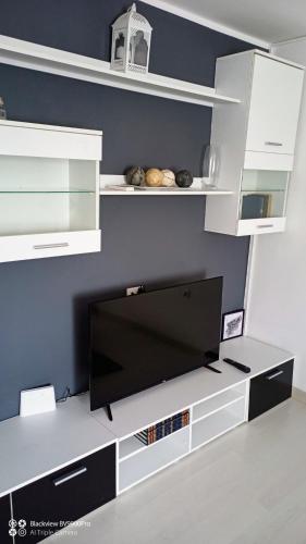 a flat screen tv sitting on top of a entertainment center at Apartman Bella Vista in Golubac