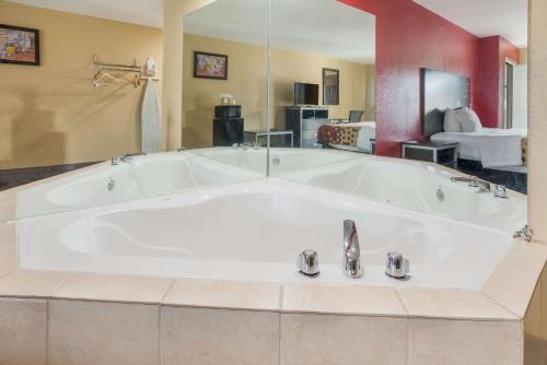 a large white bath tub in a room at Econo Lodge Lake Charles University Area in Lake Charles