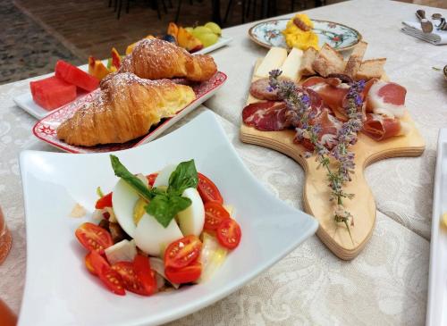 a table with two plates of food on it at Relais Cocci Grifoni - Panoramic Wine Resort in Offida