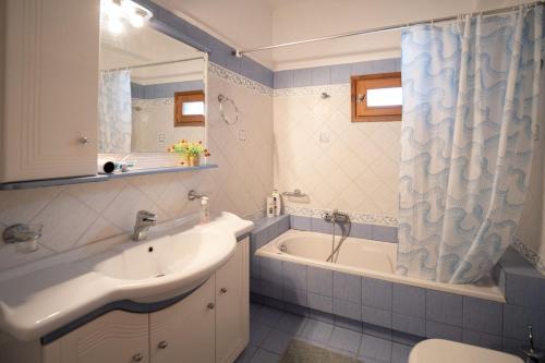 a bathroom with a sink and a tub and a shower at Majestic view Home just under Meteora Unesco Site in Kalabaka