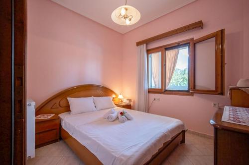 a bedroom with a bed with two stuffed animals on it at Majestic view Home just under Meteora Unesco Site in Kalabaka