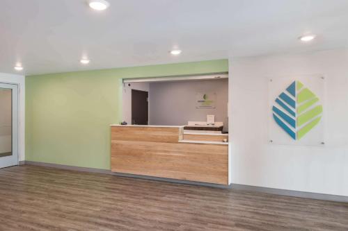 an empty room with a mirror and a waiting room at WoodSpring Suites Concord-Charlotte Speedway in Concord