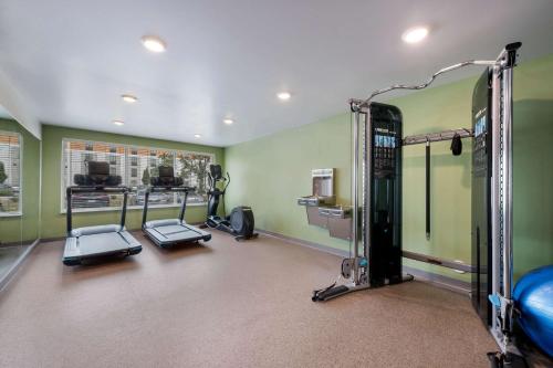 a gym with several tread machines in a room at WoodSpring Suites Concord-Charlotte Speedway in Concord
