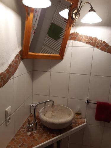 a bathroom with a sink and a mirror at Troadkasten - Ferienhaus am BIO-Bergbauernhof in Aflenz Kurort