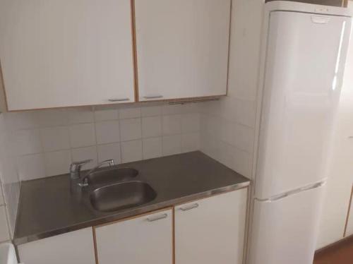 a kitchen with a sink and a refrigerator at FREE Sauna and Laundry, 5min to Metro, 15min to Center in Espoo