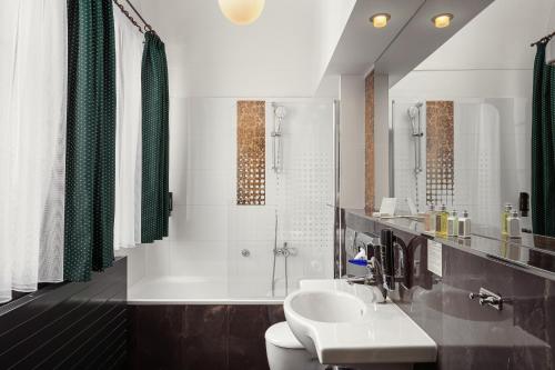a bathroom with a sink and a toilet and a shower at The Charles in Prague