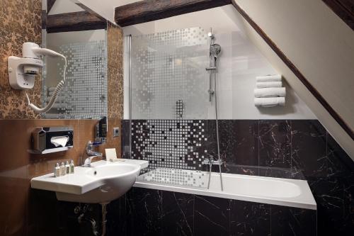 a bathroom with a sink and a shower at The Charles in Prague