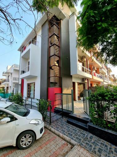 a white car parked in front of a building at Peaceful Home2 Stay by Six Lane in Sohāna