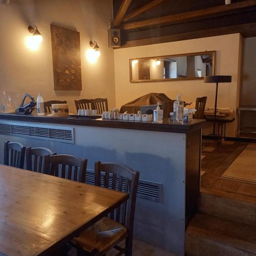 a bar in a restaurant with a wooden table and chairs at Lazareto Hotel in Monemvasia