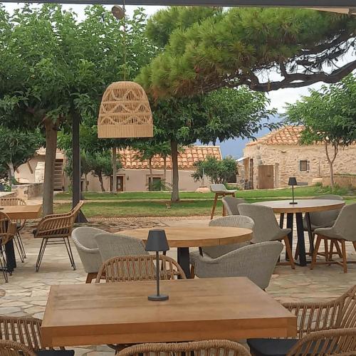 a group of tables and chairs in a patio at Lazareto Hotel in Monemvasia