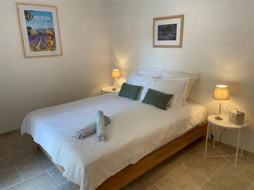 a bedroom with a bed with a blue toy on it at Le Mas de Caroline in Gargas