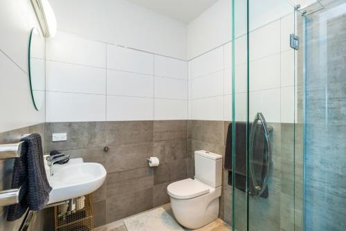 a bathroom with a toilet and a sink and a shower at Bayview Corner Suite Unit 2 - Paihia Unit in Paihia