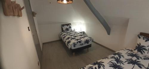 ein kleines Zimmer mit 2 Betten und einer Lampe in der Unterkunft Ferfay Holiday-Home in Ferfay