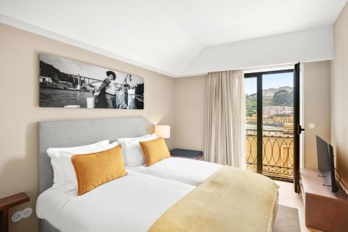a hotel room with a bed and a balcony at 108MM House in Porto