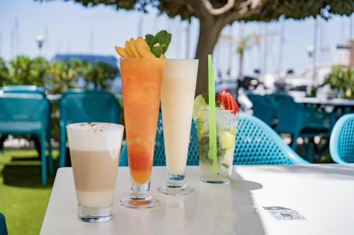 three drinks are sitting on a table at Moon Hotel & SPA. in Aguadulce