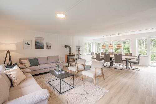 a living room with a couch and a table at Villa Hoheneck in Wildemann