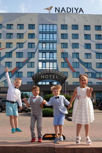 a group of children standing in front of a hotel at Nadiya Hotel in Ivano-Frankivsʼk
